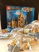 Box showing LEGO Harry Potter 75948 Hogwarts Clock Tower with pieces in clear bags and instruction booklet