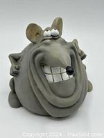Front view of vintage Paolo Chiari coin bank shaped as a smiling rat with detailed facial features and playful stance.