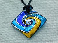 Close-up photo of the square Murano glass pendant showing a swirl of blue, gold, turquoise, and silver colors.
