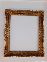 Front view showing full ornate Baroque carvings and gold finish