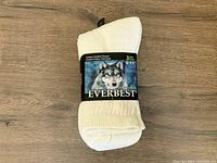 Set of three pairs of white men's socks by Everbest in new condition, size 9-11, retail packaging visible.