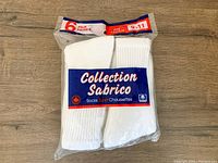 Six pairs of new white men's socks in original packaging, labeled Collection Sabrico size 9-11.