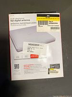 Front image showing the RCA digital flat antenna packaging with model number and features.