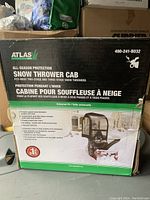 Box of Atlas Snow Thrower Cab for two-stage and three-stage snow throwers with product details on the side.