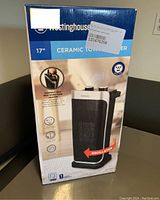 Front view of the boxed Westinghouse 17" ceramic tower heater showing brand, features, and size.