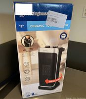 Front view of the box showing Westinghouse 17 inch ceramic tower heater with oscillation feature.