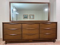 Full front view of nine-drawer dresser with rectangular mirror above
