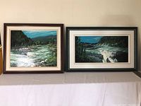 Overview of both framed landscape paintings displayed side by side