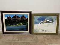 Both framed paintings side by side against wall