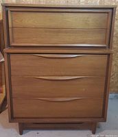 Front view of walnut veneer highboy dresser showing four drawers and tapered legs