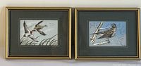 Pair of framed woven bird pictures side by side on wall