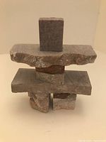 Photo showing a 4 inch Inukshuk stone figure made of stacked natural stones, with a clear view of the front side.