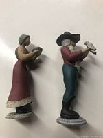 Side view photo of Mr. and Mrs. Noah figurines showing attire and poses.