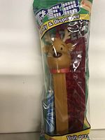 Front view of the sealed reindeer PEZ candy dispenser in original packaging with candy visible inside.