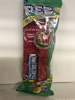 Photo of a new PEZ candy dispenser featuring Santa and sleigh design in original packaging with a pack of candy refills included.