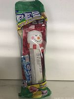Photo of snowman PEZ candy dispenser in original packaging including candy refills.
