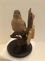 Front view of the Willow Warbler bird figurine showing detailed feather texture and brown body color on a black base.