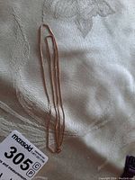 Folded gold chain on fabric background