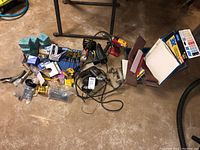 Wide shot showing all items in the lot arranged on a concrete floor in a basement area