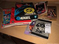 Overview of DC Heroes box, supplements, cards, Thief of Fate booklet and SSI AD&D computer game on table