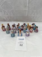 Grouping of 24 Avon collectible thimbles shaped as ladies busts in vintage hats and dresses
