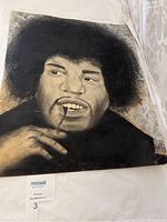 Full view of chalk art portrait of Jimi Hendrix showing face and hand holding eyeglasses.