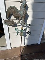 Full view of weather vane with rooster, arrow, directional markers, and mounting rod