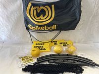 Photo showing full kit with carry bag, frame pieces, net, balls, and decals laid out on a white surface.