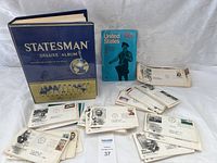 Overview of Statesman Deluxe Album, blue United States booklet, and numerous envelopes with stamps spread out