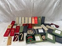 Wide view of all boxed Wallace holiday ornaments laid out on white backdrop