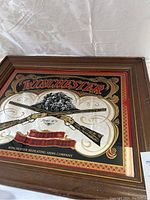 Close-up angled photo showing Winchester artwork and wooden frame details