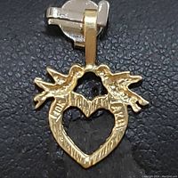 Close-up front view of the 10K yellow gold heart pendant showing textured surface and leaf-like details.