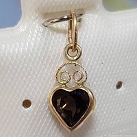 Front view of the 14K yellow gold smokey topaz heart pendant showing the gemstone and gold twisted wire accents.