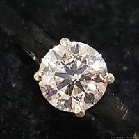 Close-up top view showing round brilliant diamond and prong setting