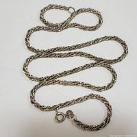 Sterling silver chain laid out to show the entire length and clasp.