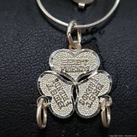 Close-up of the sterling silver pendant showing three heart-shaped sections engraved with 'Best Friends', 'Best Friends', and 'Someone Liked Me'.