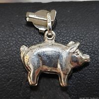 Front view of sterling silver pig-shaped pendant with bail stamped 925