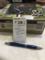 Photo of boxed American D.H.4 model airplane with visible pen for scale and MaxSold tag.