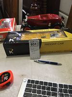 The boxed B&O freight refrigerator car model with a tape measure and pen for scale reference on a table.