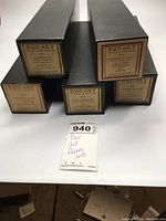 Five boxed Duo-Art player piano rolls stacked horizontally, labels on the box ends visible with titles and Duo-Art logo.