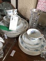 Noritake Violets china set pieces stacked showing plates, teacups, saucers with floral violet pattern and gold accents