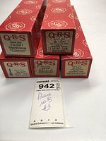 Five QRS branded piano rolls in original red boxes with visible product labels and titles.