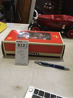 Photo of the Lionel Porky Pig handcar in its original box with label showing lot number and name.