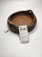Photo showing top and side view of Roseville Imperial bowl with handwritten tag and price sticker attached.