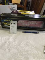 Boxed Weaver Ultra model fridge car for wines with brand logo and product details visible, along with adjacent items as size references.