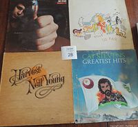 Four vintage LP record album covers: Don McLean American Pie, Neil Young Harvest, Crosby Stills Nash & Young So Far, Cat Stevens Greatest Hits