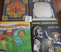 Four LP records laid out on floor showing cover art and condition