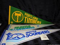 Photo showing Portland Timbers and two Seattle Sounders soccer pennants.