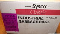 Box front showing brand Sysco Classic and product description as Industrial Garbage Bags 20" x 22", quantity approx 500