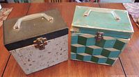 Two vintage 45 RPM record cases closed, showing their external condition and handles.